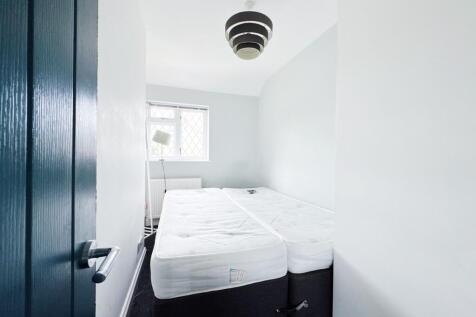 Bright, freshly painted small bedroom with two ...