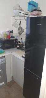 Compact fitted kitchen with modern black Samsun...