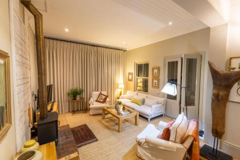 Cozy living room with studio or office next door