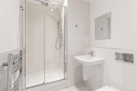 Experience the elegance of this modern bathroom featuring a stylish glass shower.