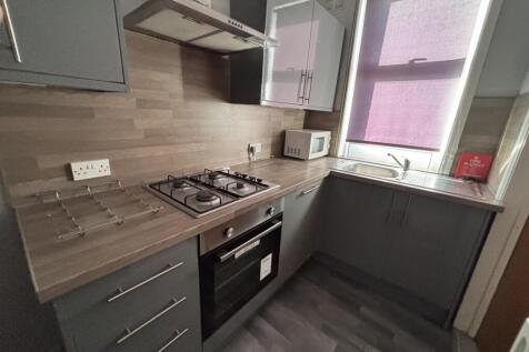 Bright and modern kitchen with ample counter sp...