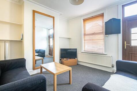 Bright, well-kept living room with two sofas, a...