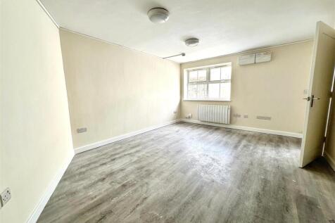Spacious bright room with stylish wood flooring...