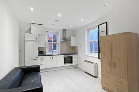 Located on the second floor, this spacious studio apartment is situated at the corner of Heneage Street and Brick Lane. The accommodation is offered furnished and includes an entrance hall, a combined