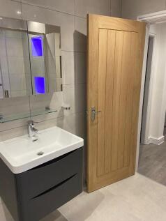 Contemporary bathroom with a sleek wall-mounted...