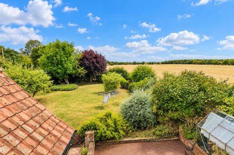 Sunlit Garden Overlooking Countryside.png