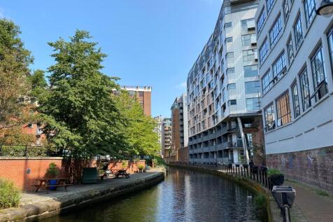 Modern two-bedroom, two-bath canal-side apartment with open plan living, private balcony, en-suite, utility room, allocated secure parking space, and fantastic views. A great city centre abode.