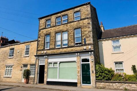 A well-presented partly furnished two-bedroom, two-bathroom property featuring a spacious open-plan kitchen and living area. The bright living room boasts attractive exposed beams, adding character an