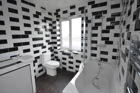 Modern bathroom featuring geometric black and w...
