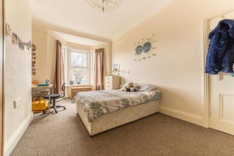 A bright and inviting double bedroom with ample...