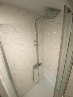 Modern bathroom shower area featuring stylish m...