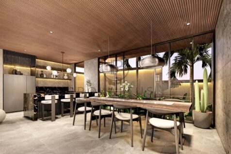 Modern dining area with a long wooden table surrou