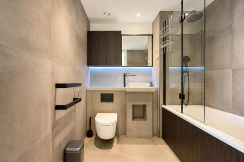 Modern 1-bedroom, 1-bathroom apartment at Key Bridge, Exchange Gardens (SW8), Vauxhall. Featuring a private balcony, swimming pool, spa, gym, concierge, lift access, dishwasher, and dryer. Ideally loc