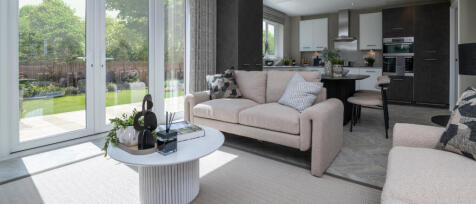 Mofern living room with a 2 eated sofa, 2 large window doors with a sunny garden view at Pilgrims Ch