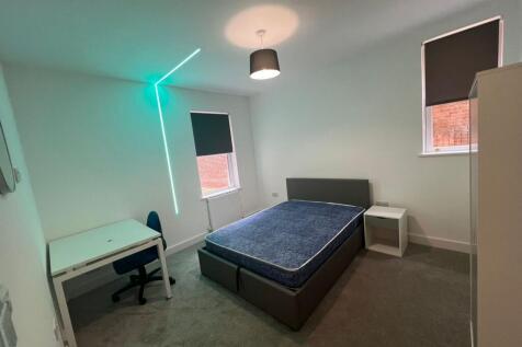 Bright, modern bedroom with a double bed, bedsi...