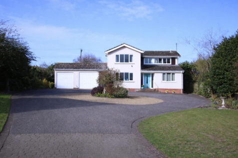 Modern house with landscaped driveway.png