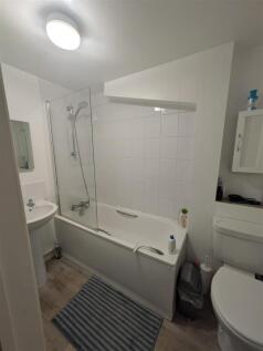 Bright bathroom with modern shower and bathtub....