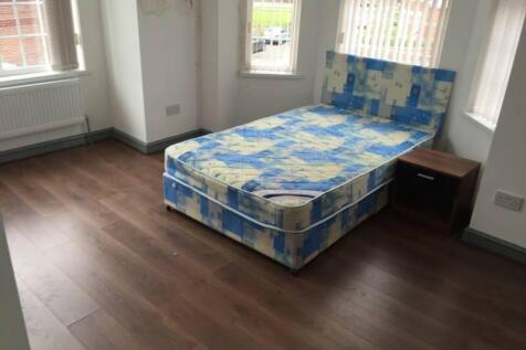Bright corner double bedroom with three tall wi...