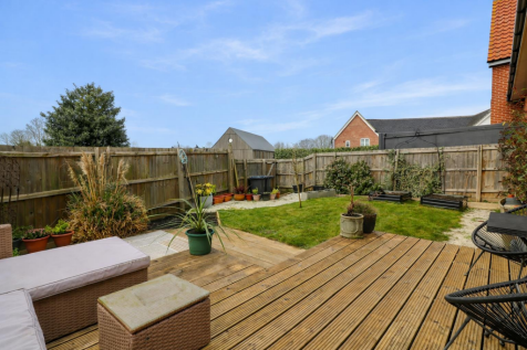 Sunny garden with wicker furniture.png