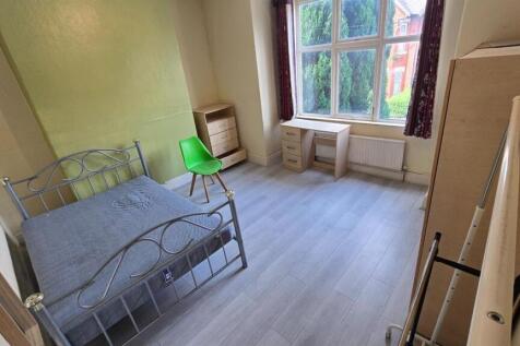 Bright double bedroom with a metal double bed, ...