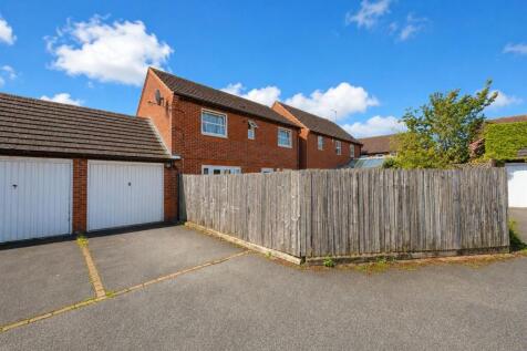 The Rear with the Driveway and Garage