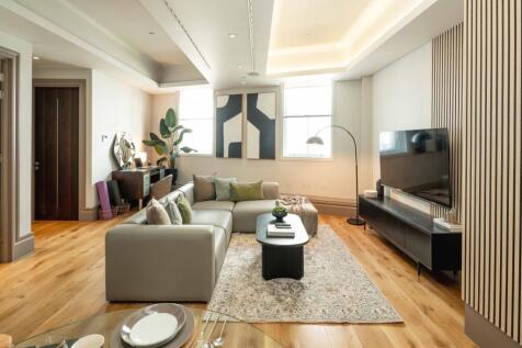 Bright, modern living room with a large L-shape...