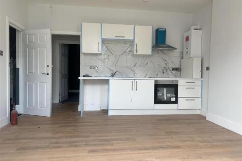 Bright modern kitchen with marble effect splash...