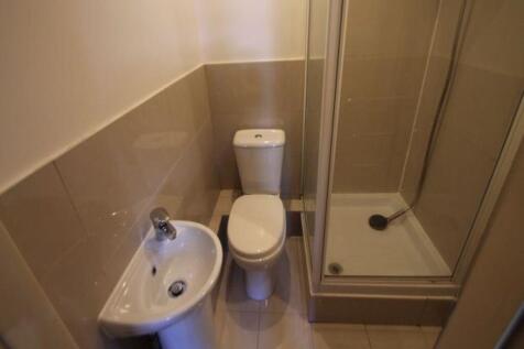 A clean and modern bathroom featuring a toilet,...