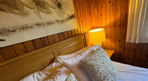 Furnished Double Bedroom With Warm Pine Clad Walls