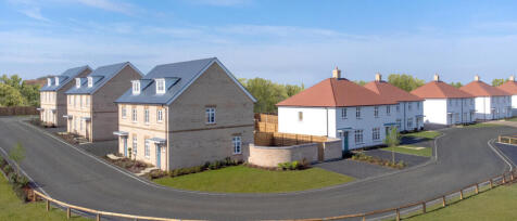 Newly built semi-detached and detached houses with well-maintained gardens and curved asphalt roads