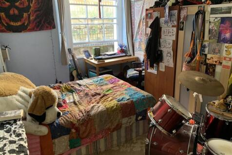 Bright furnished bedroom with desk and decor...