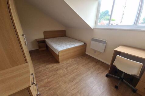 A cozy student bedroom featuring a neat single ...