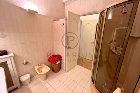 Spacious bathroom featuring a glass-enclosed showe