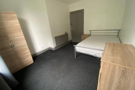 A tidy double bedroom featuring a sturdy metal ...