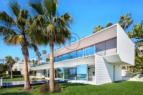 Modern two-story house with large glass windows, s