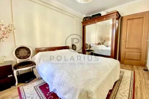 A cozy bedroom with a double bed covered in a whit