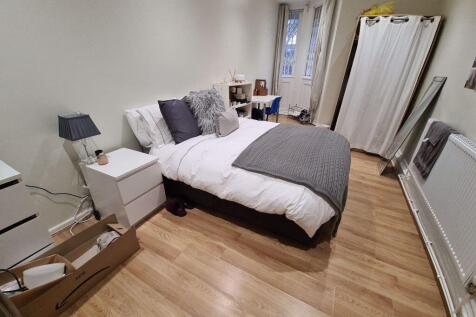 A cozy and well-maintained bedroom featuring a ...