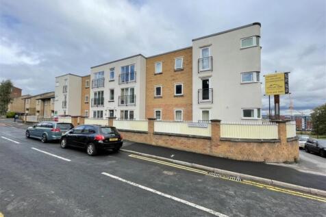 Modern three-storey apartment building on a qui...