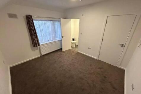 Spacious double bedroom with a large window pro...