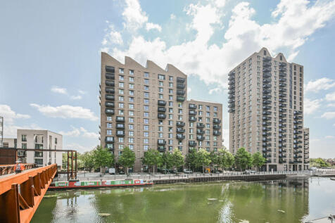 LONG LET. A stylish 1 bedroom fourth floor apartment featuring bright open-plan living space, a private balcony with attractive waterside views and modern interiors throughout, set within a sought-aft