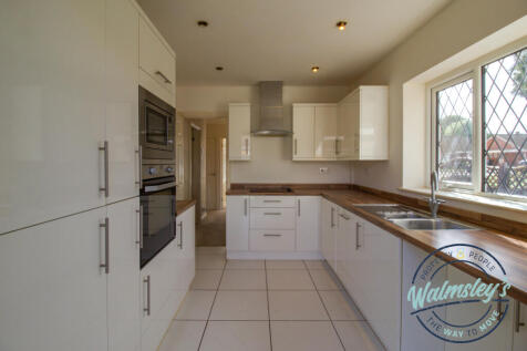Modern fitted kitchen towards hallway