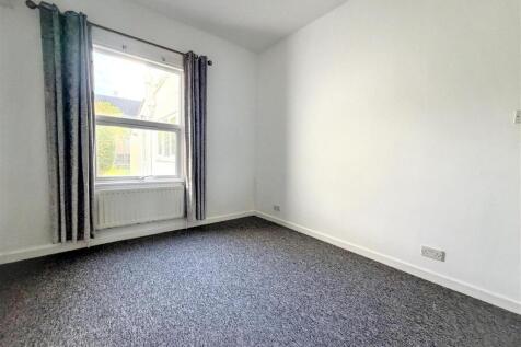 Bright, clean bedroom with fresh grey carpeting...