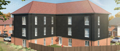 Modern three-storey housing with a brick ground floor, black wooden upper levels, and a red tiled ro