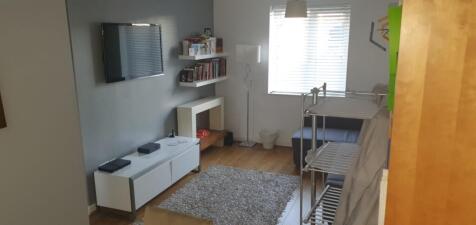 Bright, modern living room with a wall-mounted ...