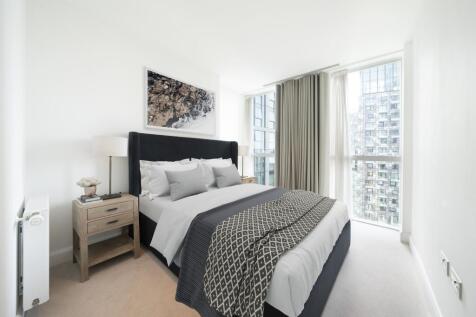 Experience serene luxury in this beautifully designed bedroom offering abundant natural light and chic decor.