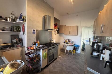 Bright, well-equipped galley kitchen with full-...