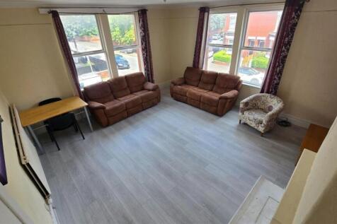 Bright, modern living room with large bay windo...