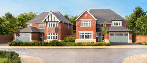 Two modern red-brick houses with grey tiled roofs and white window frames, surrounded by greenery on