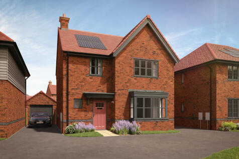 A red brick house with solar panels on the roof sits in the foreground