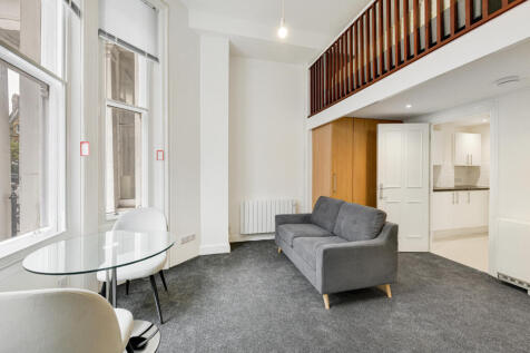 The property comprises a main studio room with fitted wardrobes and mezzanine sleeping area, separate fully fitted kitchen appliances. It also includes a stylish bathroom.